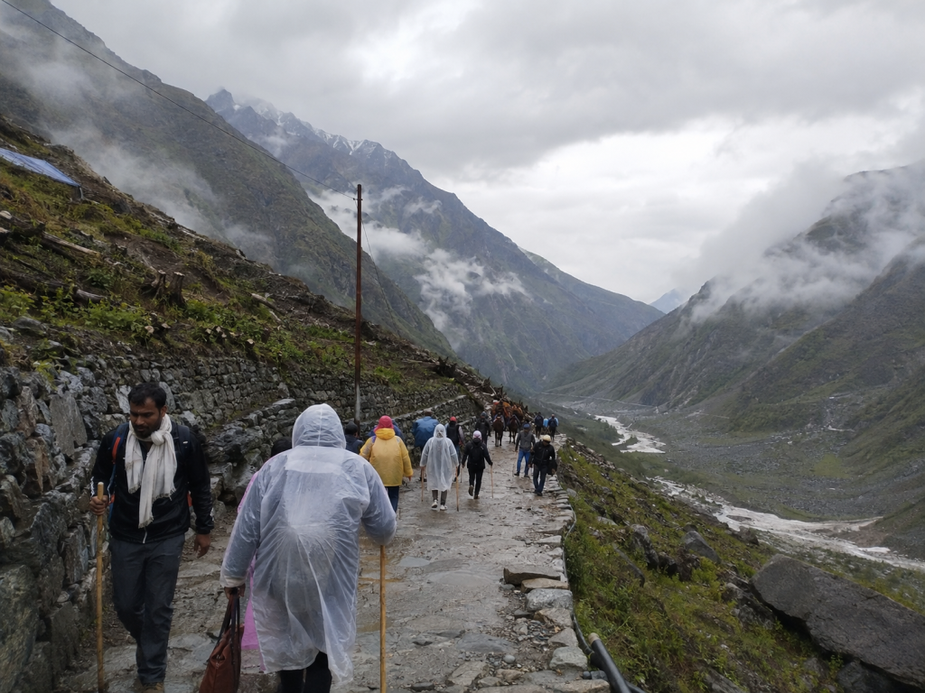 Pilgrims walking on the Kedarnath route during cloudy or light-rain conditions